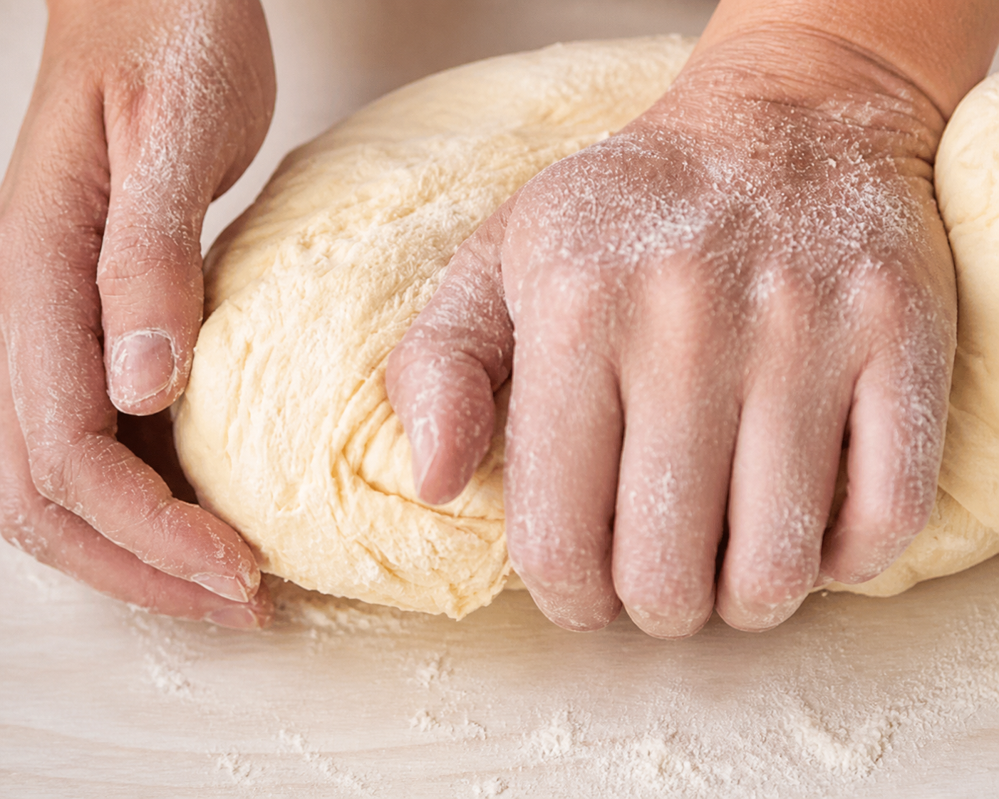 Soft apple pie dough being kneaded by hand